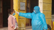 Kiểm tra thân nhiệt cho công dân trong khu cách ly theo dõi chống dịch Covid -19.